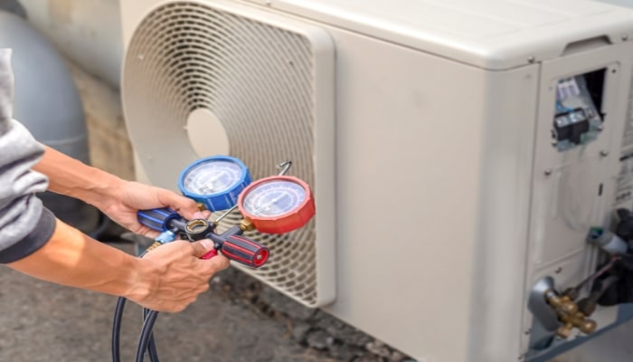 Technician Working On Heat Pump Technician Working On Heat Pump