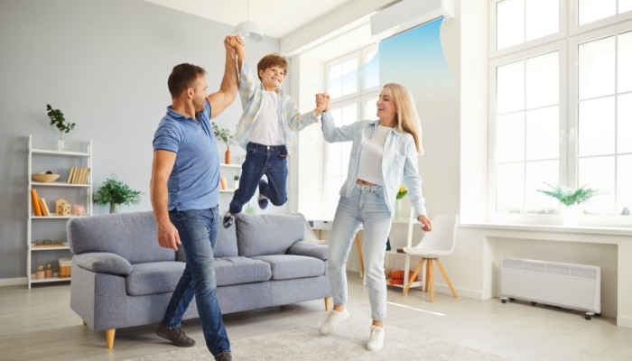 Family In Livingroom With Ac Blowing Family In Livingroom With Ac Blowing